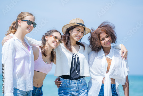 Happy women with friend are playing on the beach While relaxing on vacation for the weekend on sunny day.