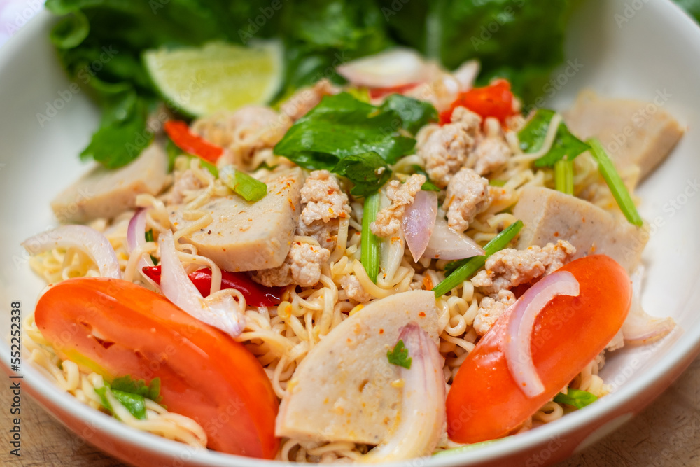 Close up look of Instant noodle spicy salad with spice, Pork, sausage and vegetable ,Spicy Noodle Salad, Mama Noodle Salad, Yum Mama, Thai Street Food. Asian food.