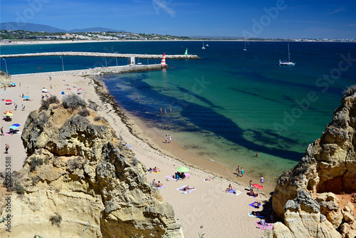 mouth of Bensafrim river and Batata beach at Atlantic Ocean, invasion of algae - rugulopterix okamurae - seen on the beach and in the water, Lagos, Faro, Algarve, Portugal, Europe photo