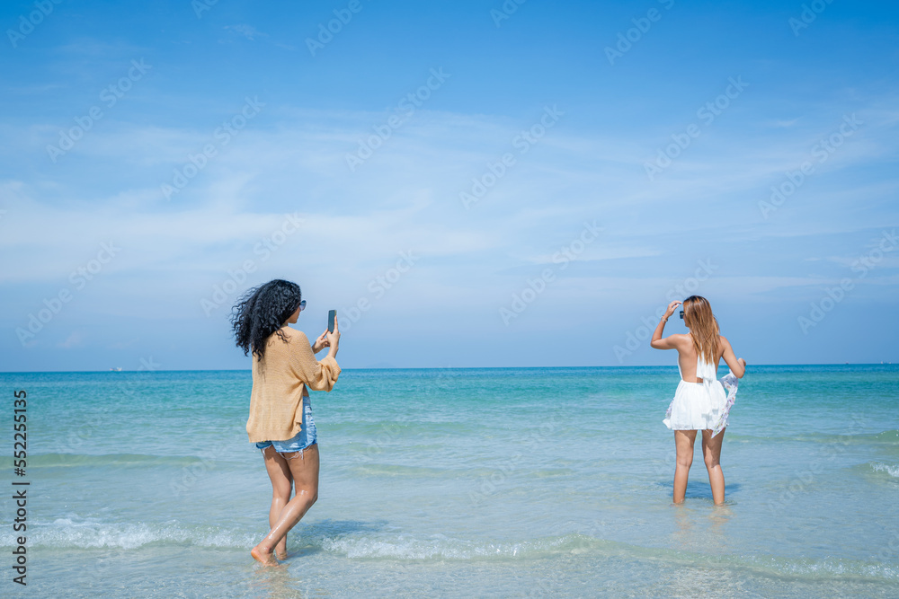Beautiful girls and friend having fun together on the beach,Nice weather in travel and holiday concept.