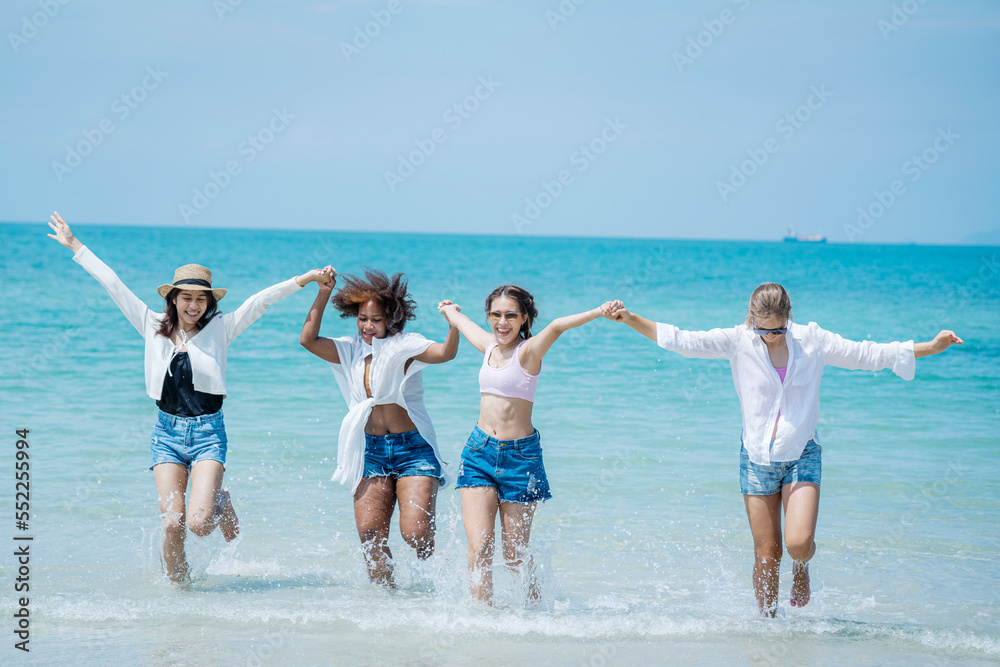Beautiful girls and friend having fun together on the beach,Nice weather in travel and holiday concept.