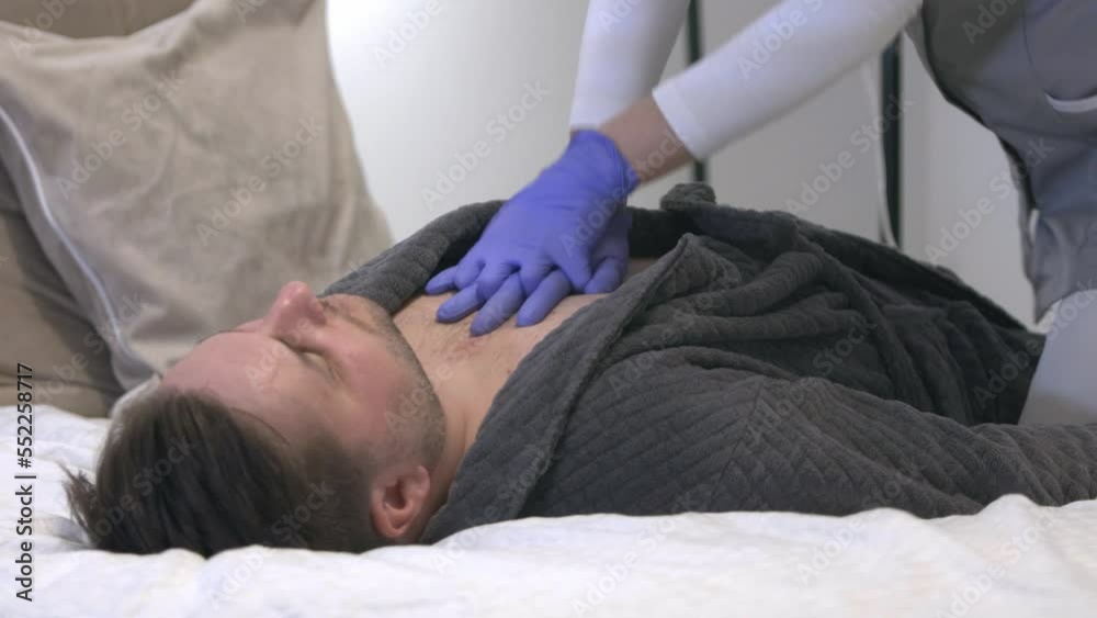 female nurse performing cardiac massage on caucasian male laid on bed room hospital clinic female nurse performing cardiac massage on caucasian male laid on bed room hospital clinic