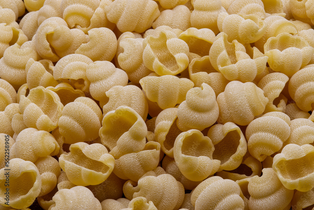 Raw Italian Gnocchi Napoletani Pasta as background.