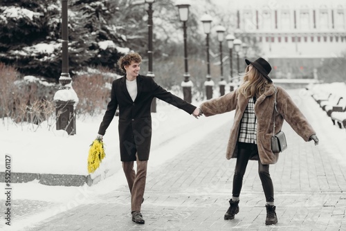 Smiling young woman with mimosa flowers International Women's Day.