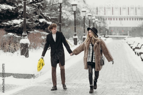 Smiling young woman with mimosa flowers International Women's Day.