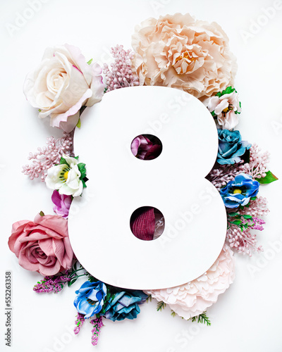 creative floral layout. number eight shape decorated with flowers isolated on white background. top view. copy space. flat lay. photo