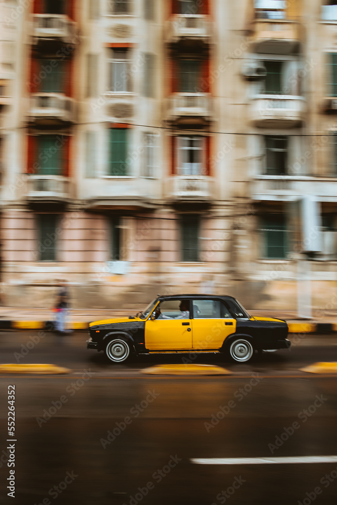 Blurred motion picture of yellow cab on city street