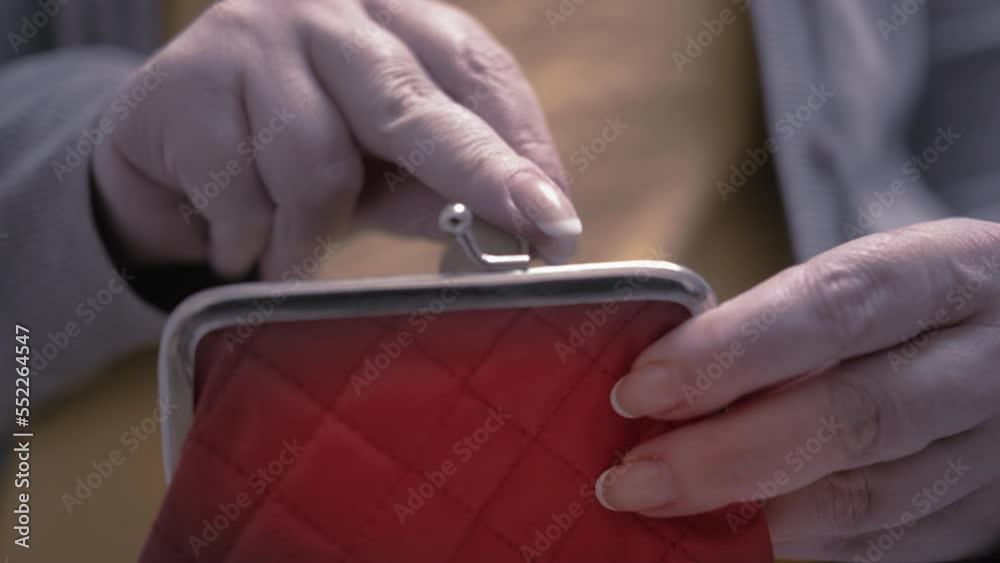 close up of woman hands counts pennies and puts them in her wallet, economic crisis, electricity bills, static shot close up of woman hands counts pennies and puts them in her wallet, economic crisis, electricity bills, static shot