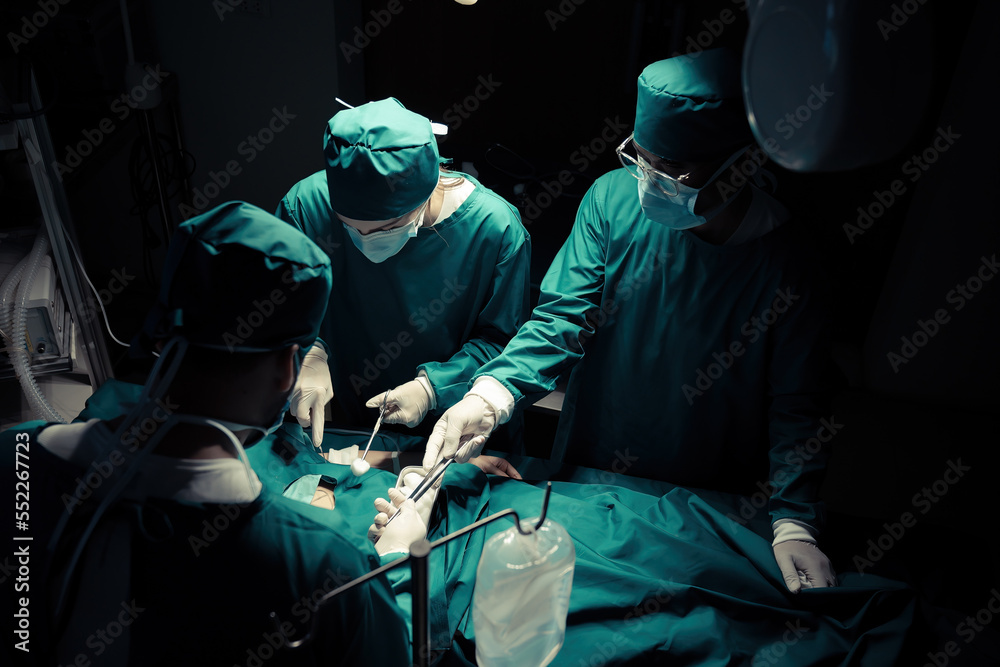 A team of professional doctors perform surgery in a hospital, a group of surgeons working in the operating theater.