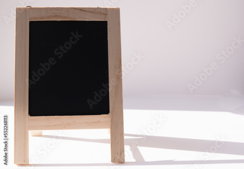 Small blackboard with copy space with light on white background