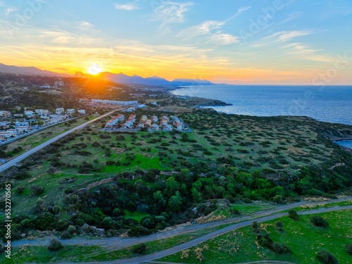 Sunset with green field which is land for real estate in Esentepe  North Cyprus