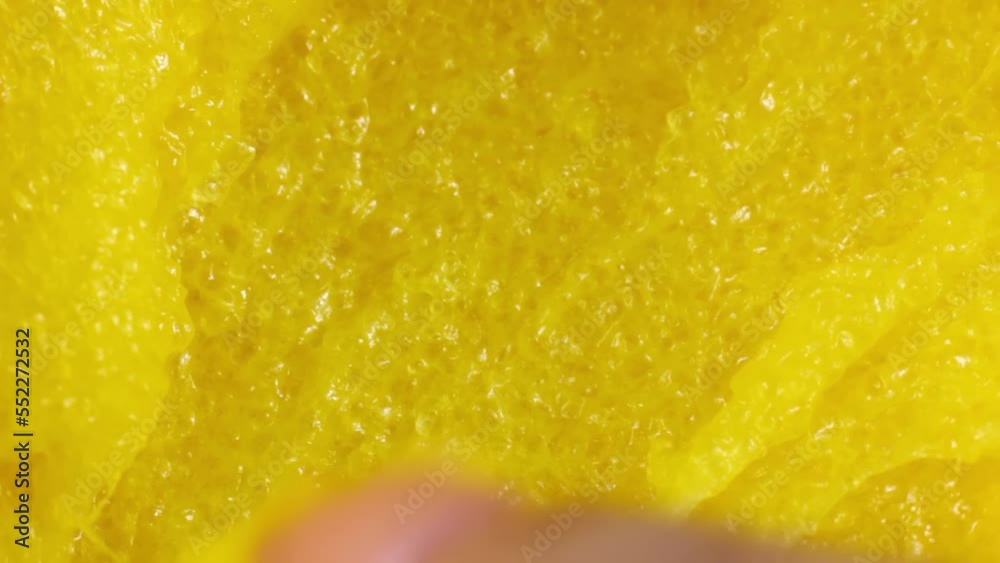 Woman finger touching yellow sugar cosmetic scrub close up Woman finger touching yellow sugar cosmetic scrub close up