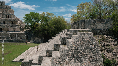 Woman climbing the ruins of the mayas pyramids at Edzna, Yucatan 