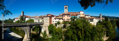 View of historic centre of Cividale del Friuli with medieval stone Devil Bridge (Ponte del Diavolo) over Natisone river, Italy