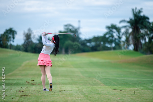  Professional woman golfer teeing golf in golf tournament competition at golf course for winner. 