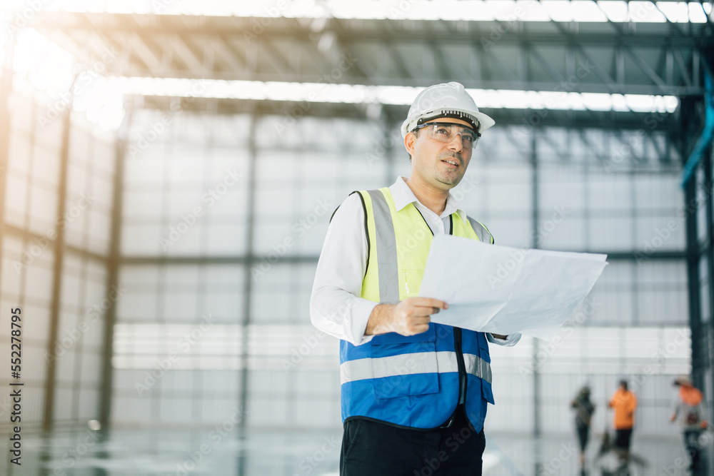 warehouse manager with tablet and ..radio communication his worker working in background in warehouse distribution center environment. Business warehouse inventory,contruction warehouse warehouse manager with tablet and ..radio communication his worker working in background in warehouse distribution center environment. Business warehouse inventory,contruction warehouse