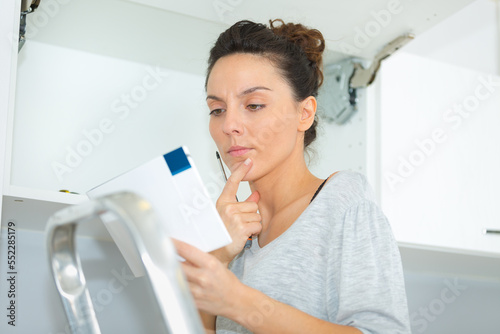 portrait of young woman reading instructions