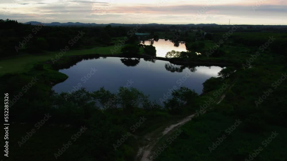 Charming aerial view on a lake during sunset with birds flying around Charming aerial view on a lake during sunset with birds flying around