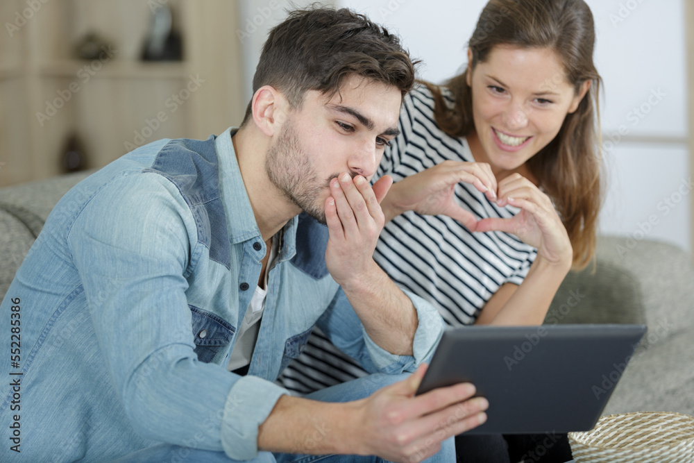 young couple chatting with family over a video call young couple chatting with family over a video call