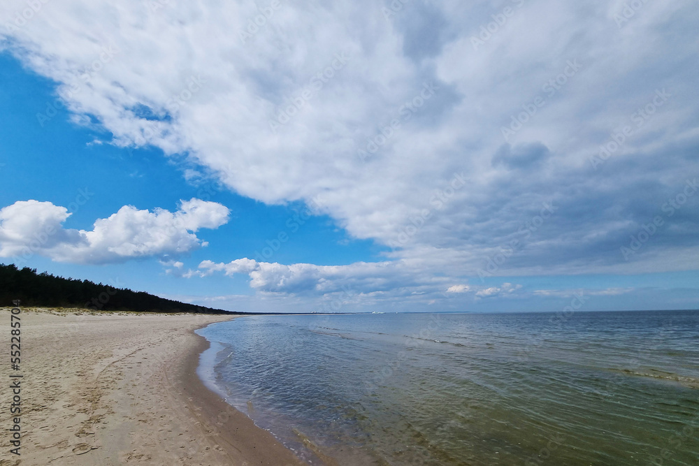 Baltic Sea coast. Light sand on the beach. A sunny day.