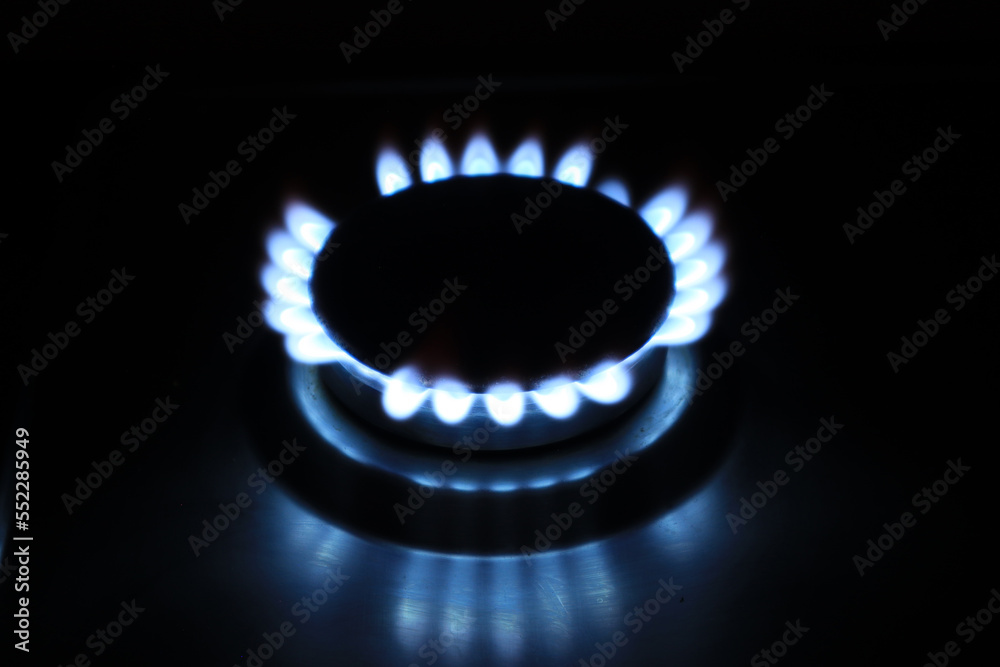 Top view of a burning gas burner with blue gas on a dark background
Top view of a burning gas burner with blue gas on a dark background