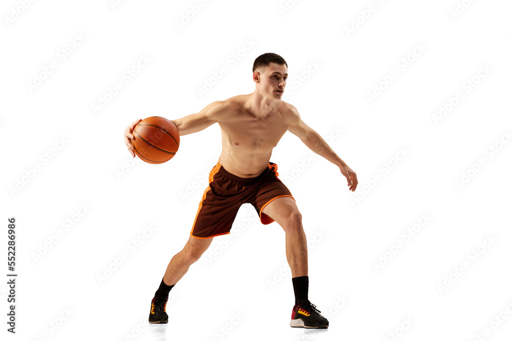 Dribbling. Dynamic footage of professional basketball player training with basketball ball isolated over white background. Sport, action, active and healthy lifestyle