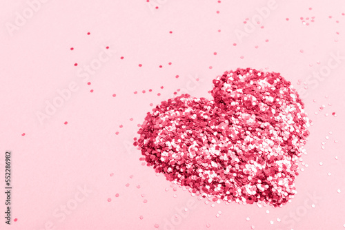 A heart made of small sequins. Color 2023, viva magenta. Space for copying. Flat position, top view