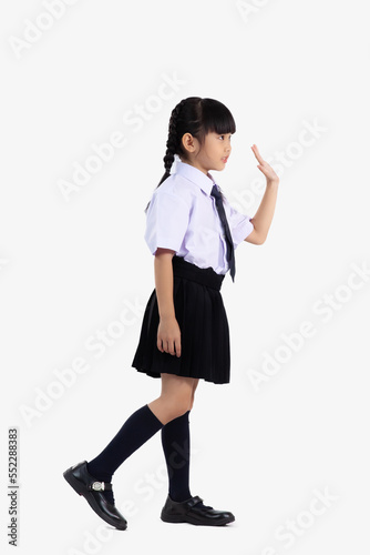 Asian student international school in uniform standing full length waving hand on white background.