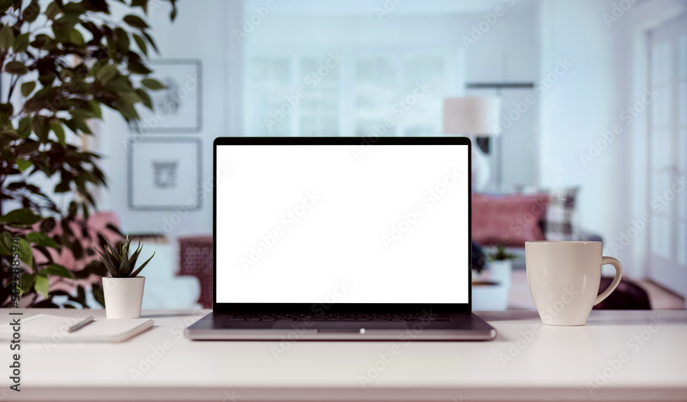 Modern laptop with blank white screen for copy replacement, cozy home light interior with cup of steaming coffee Modern laptop with blank white screen for copy replacement, cozy home light interior with cup of steaming coffee