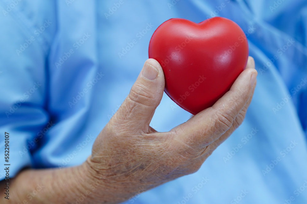 Fototapeta premium Asian elder senior woman patient holding red heart in hospital.