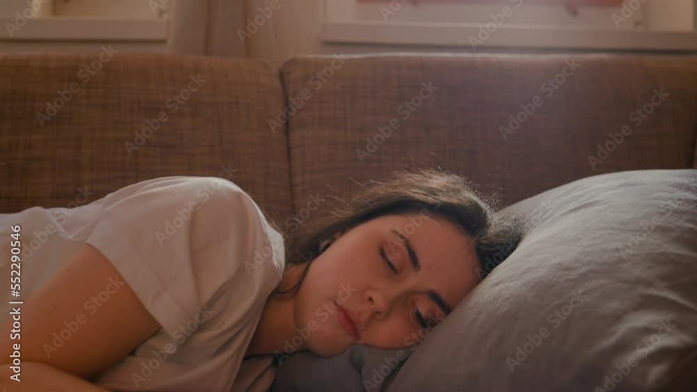 Psychotherapy. Sad alone young caucasian woman lies tiredly on sofa. Zoom in shot. Stress and problems. Concept of psychology and depressed. Psychotherapy. Sad alone young caucasian woman lies tiredly on sofa. Zoom in shot. Stress and problems. Concept of psychology and depressed.