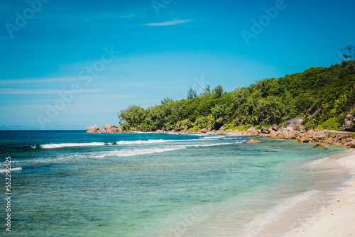 Fototapeta Naklejka Na Ścianę i Meble -  Big granite rocks on the Grand Anse beach. La Digue island, Seychelles. Tropical landscape with sunny sky.
