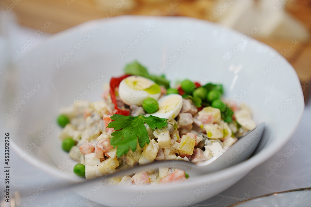 a plate with traditional Russian olivier salad. a plate with traditional Russian olivier salad.