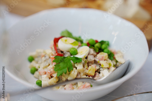 a plate with traditional Russian olivier salad. 