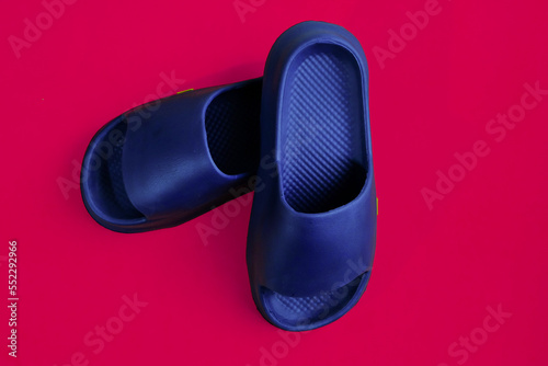 Men's rubber home slippers isolated on a magenta background