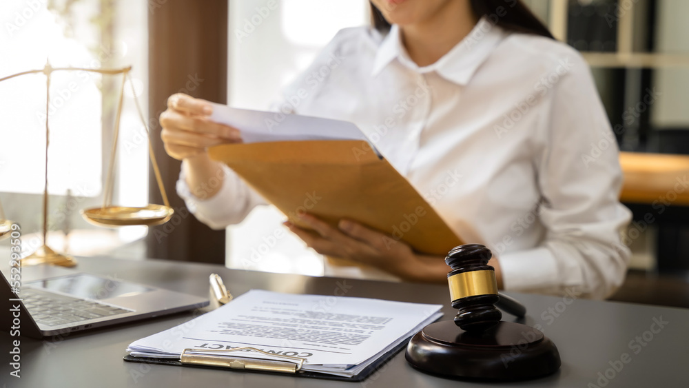 Lawyer woman working with paperwork on his desk in office workplace for consultant lawyer in office.