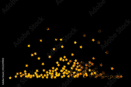 Golden confetty stars on a black background. Design element for a greeting card or party invitation