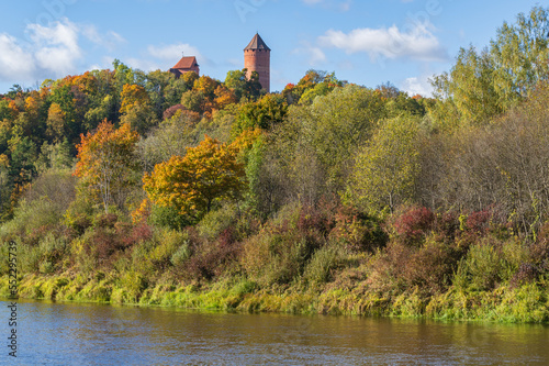 View to Turaida Castle on sunny autumn day. River of Gauja in the foreground