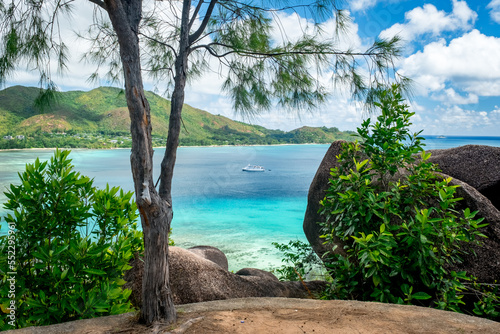 Praslin Seychelles tropical island with withe beaches and palm trees. Aerial view of tropical paradise beach with white sand and turquoise crystal clear waters of Indian Ocean