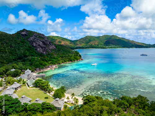 Fototapeta Naklejka Na Ścianę i Meble -  Praslin Seychelles tropical island with withe beaches and palm trees. Aerial view of tropical paradise bay with granite stones and turquoise crystal clear waters of Indian Ocean