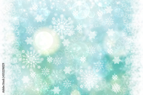 Abstract blurred festive delicate winter christmas or Happy New Year background texture with shiny light turquoise blue and bright bokeh lighted stars and snowflakes. Card concept.
