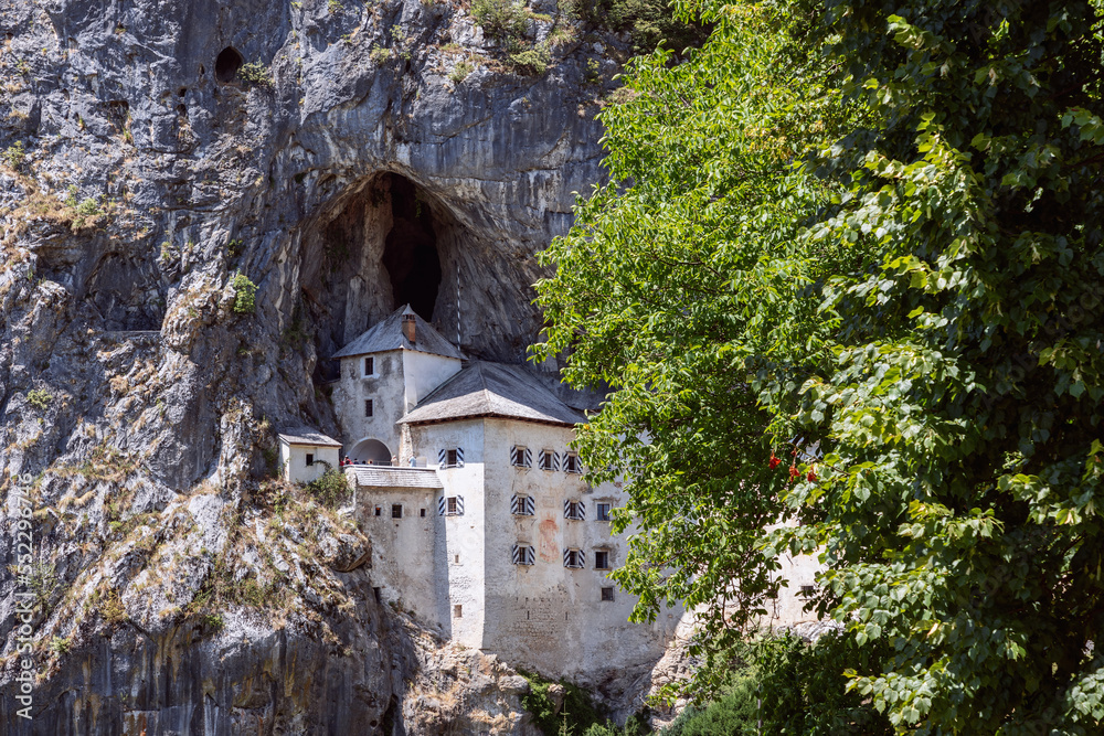 In 1570, the current Predjama Castle (Predjamski grad) was built in the Renaissance style, pressed next to a vertical cliff under the original medieval fortification, Postojna, Slovenia In 1570, the current Predjama Castle (Predjamski grad) was built in the Renaissance style, pressed next to a vertical cliff under the original medieval fortification, Postojna, Slovenia