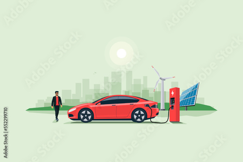 Flat vector illustration of a red electric car charging at the charger stand on the street with green city skyline in the background. Renewable electricity energy solar and wind power station.
