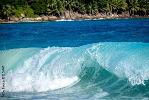 Big turquoise wave on the beautiful tropical paradise beach Anse Intendance at Seychelles, Mahe.
