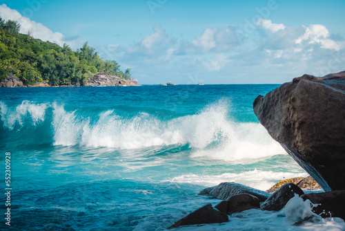 Big turquoise wave on the beautiful tropical paradise beach Anse Intendance at Seychelles, Mahe. photo