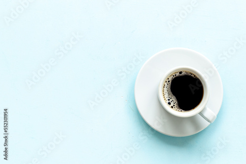 White cup of hot black coffee top view. Coffee break time concept