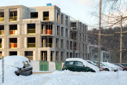 Unfinished constructions of apartments during winter. Housing crisis, building companies go bankrupt and leave unfinished buildings. © CrispyMedia