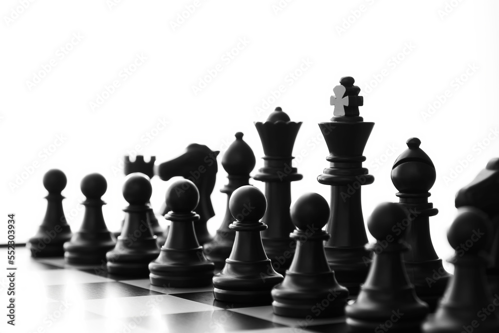 Isolated black Chess army ready for battle on a board with blurred perspective view. Intellectual games and leisure activity concept. Cut out template
