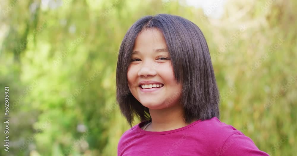 Video of portrait of happy asian girl posing in garden Video of portrait of happy asian girl posing in garden