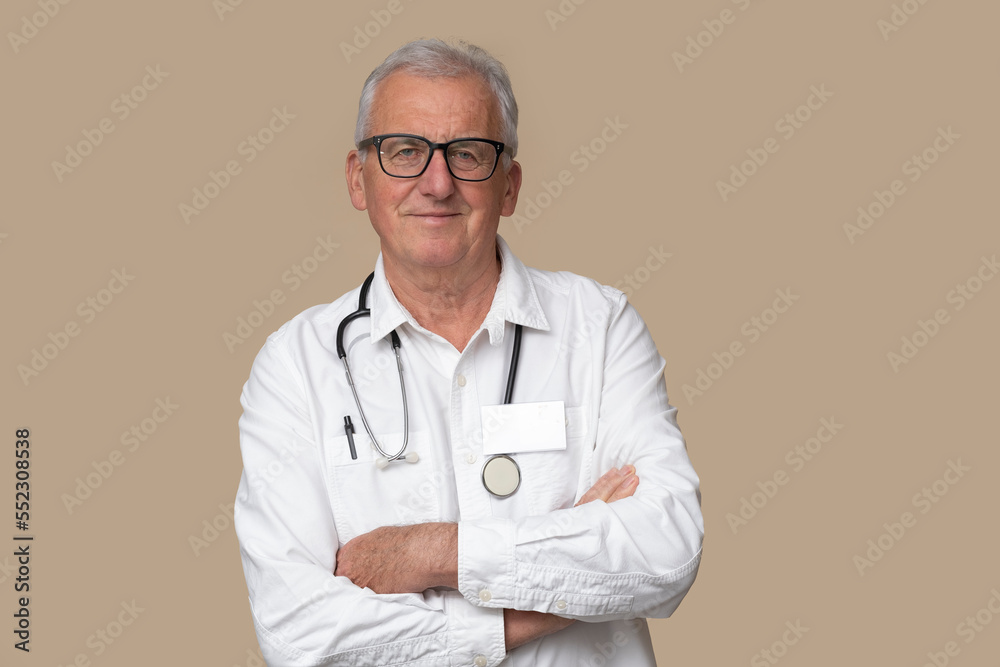 Older doctor in eyeglasses with stethoscope and white uniform on light brown background. Older doctor in eyeglasses with stethoscope and white uniform on light brown background.